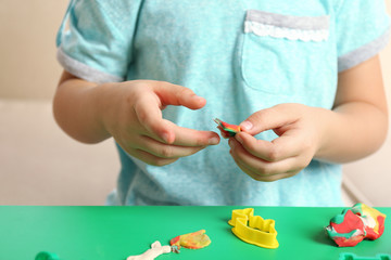 Child sculpts from plasticine, closeup