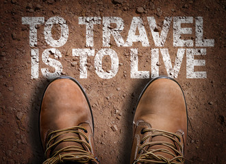 Top View of Boot on the trail with the text: To Travel Is To Live