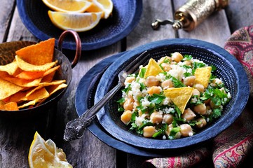 Fototapeta na wymiar chickpea salad with couscous, parsley, olive oil and tortilla chips.