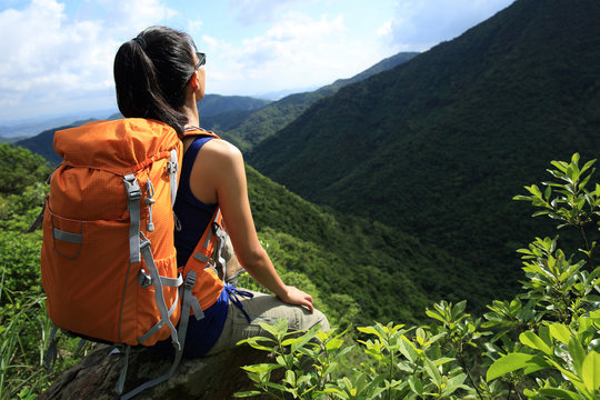 young woman backpacker  enjoy the view on mountain peak