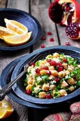 chickpea salad with couscous, parsley, olive oil with pomegranate