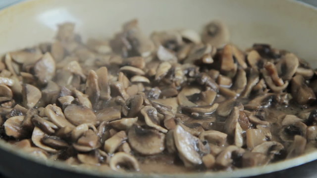 Grinded mushrooms roasting in pan.