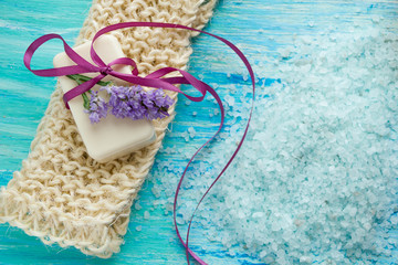 natural organic soap  and sea salt   on a blue wooden table, Spa with flowers