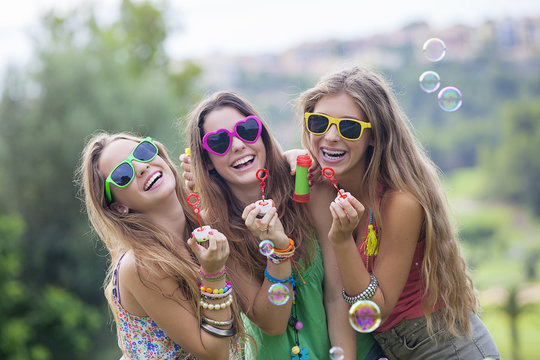 teen girls blowing bubbles