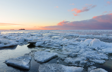 Ice melting on the beach in the sunset