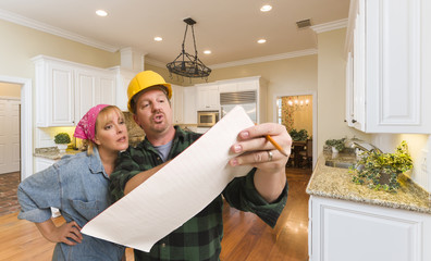 Contractor Discussing Plans with Woman Inside Custom Kitchen Int