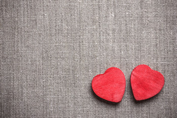 Wooden heart shape on linen fabric.