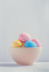 Bowl of colorful easter eggs with copy space