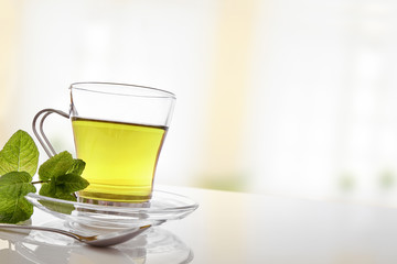 Cup of green tea with mint front diagonal view