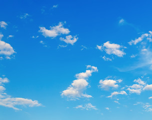 Naklejka na ściany i meble Blue sky background with a few white clouds.