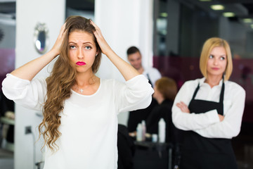 Displeased client and hairdresser.