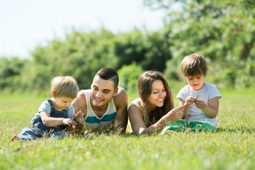 Family of four in sunny park