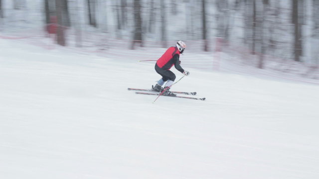 Close-up skier skiing downhill in forest