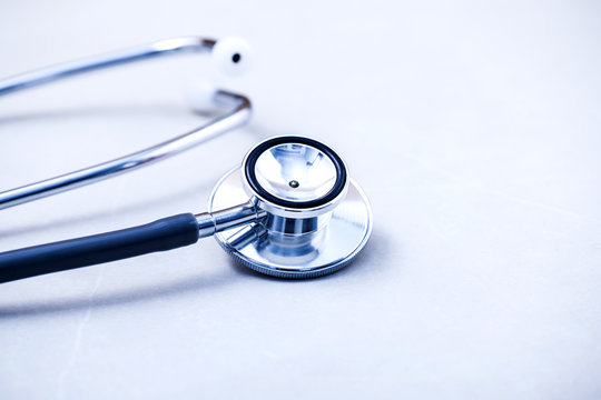 Stethoscope On White Table With Shallow Depth Of Field For Medic