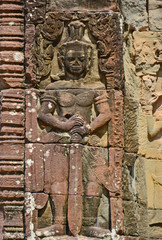 Fototapeta na wymiar unique carving of khmer dvarapala stands guard asparas found on the wall temple ruins of angkor wat, Siem Reap, Cambodia.