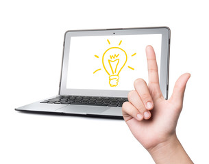 hand and light bulb on laptop ,Idea concept