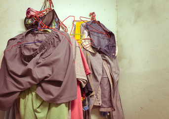 vintage old tone of clothes on hangers in room