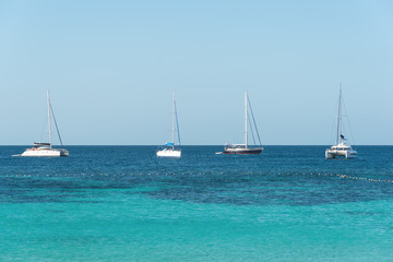 Fototapeta na wymiar Yacht sailing on tropical sea at windy day