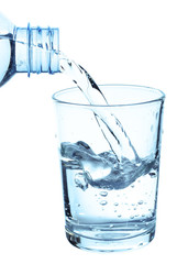 Pouring water on a glass on white background