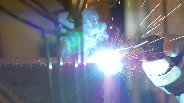Welding metal welding machine. Spatter, work gloves melt metal iron construction