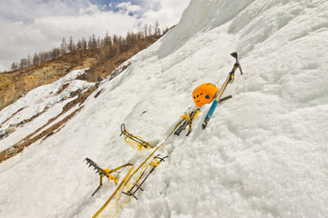 Homemade new crampons, helmet, ice ax in the snow
