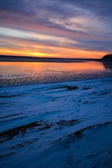 Fototapeta na wymiar Winter Sunset over frozen lake