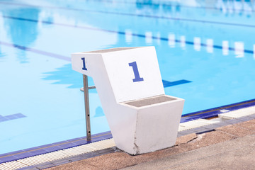 jumping stand marked number three in the first lane of swimming pool, water sport, swimming pool center 