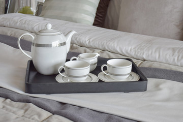 Fototapeta na wymiar elegant tea cup set on black tray in modern bedroom interior
