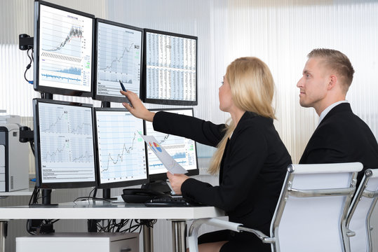 Financial Workers Analyzing Data In Office