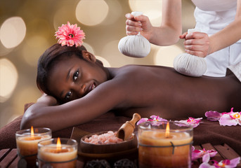 Obraz na płótnie Canvas Portrait Of Woman Enjoying Herbal Massage At Spa
