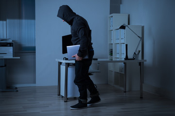 Robber Stealing Laptop From Office At Night