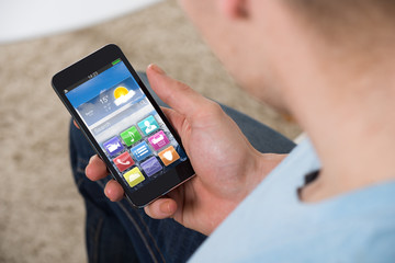 Man Holding Smartphone With Colorful Application Icons