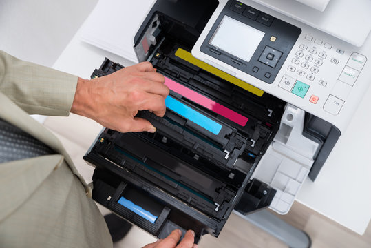 Businessman Fixing Cartridge In Photocopy Machine