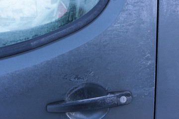 door of the car covered with frost