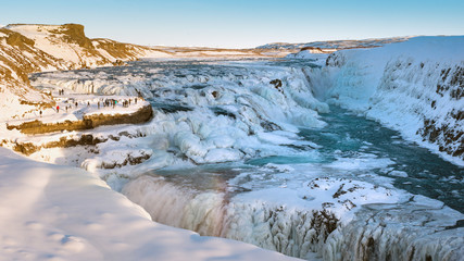 Gullfoss, waterfall in iceland in winter with a little rainbow