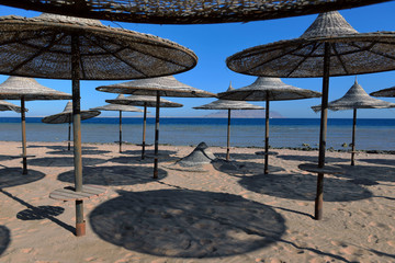 thatched umbrellas on the beach