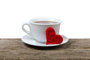 Cup of coffee and heart on a wooden table