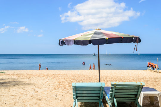 Beach chair under the colorful umbrella on the layan beach Phuket, Thailand
