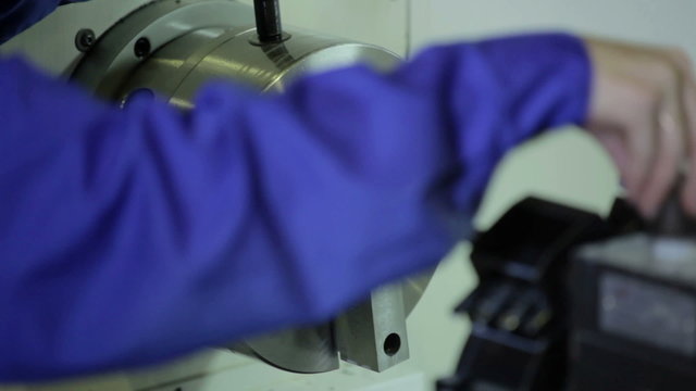 Lathe works metal in factory