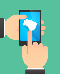 Hands using a phone showing  a map of Brazil