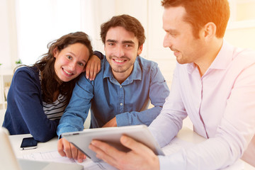 young serious couple meeting a real estate agent