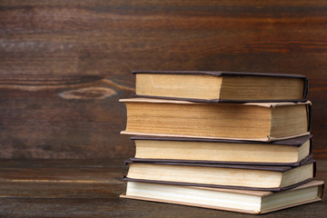 Fototapeta premium books in the light and dark cover folded stack on the wooden table
