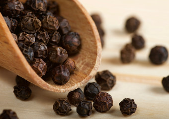 black pepper corn on wooden spoon
