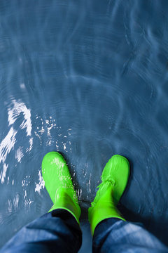 green rubber boots in the water