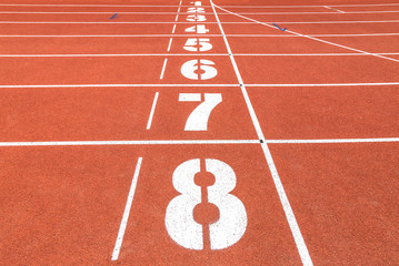Running track in stadium with numbers.