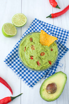 Guacamole with nachos, chili peppers