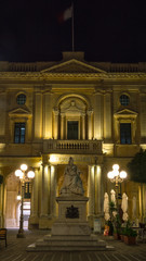 Fototapeta na wymiar Queen Victoria statue, Bibliotheca building by night Republic Square Valletta Malta by night