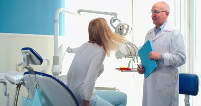 Young woman coming to experienced dentist for regular checkup visit