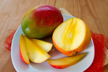 Naklejka na ściany i meble Mango fruit on wooden background.