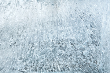 Fototapeta na wymiar Glacial transparent wall of ice with patterns.